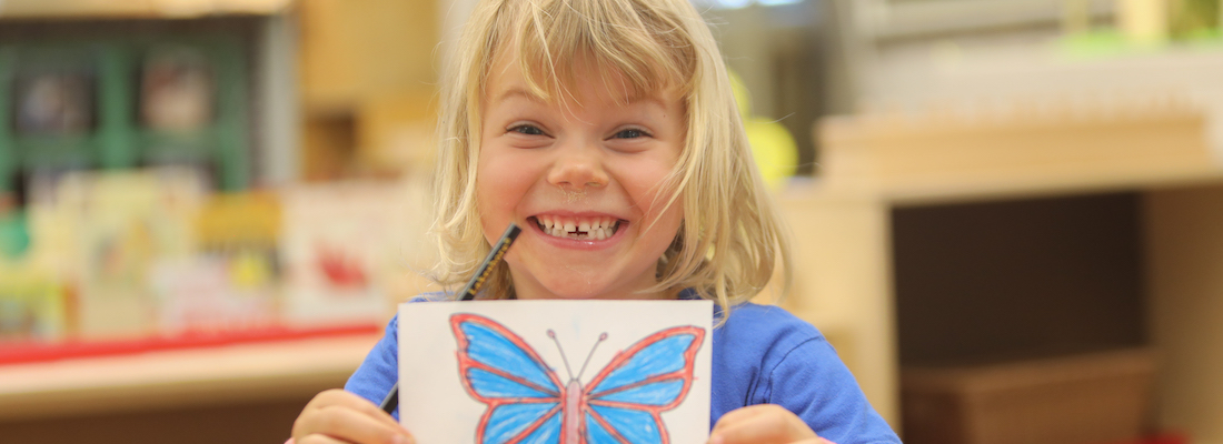 Student with a butterfly coloring picture
